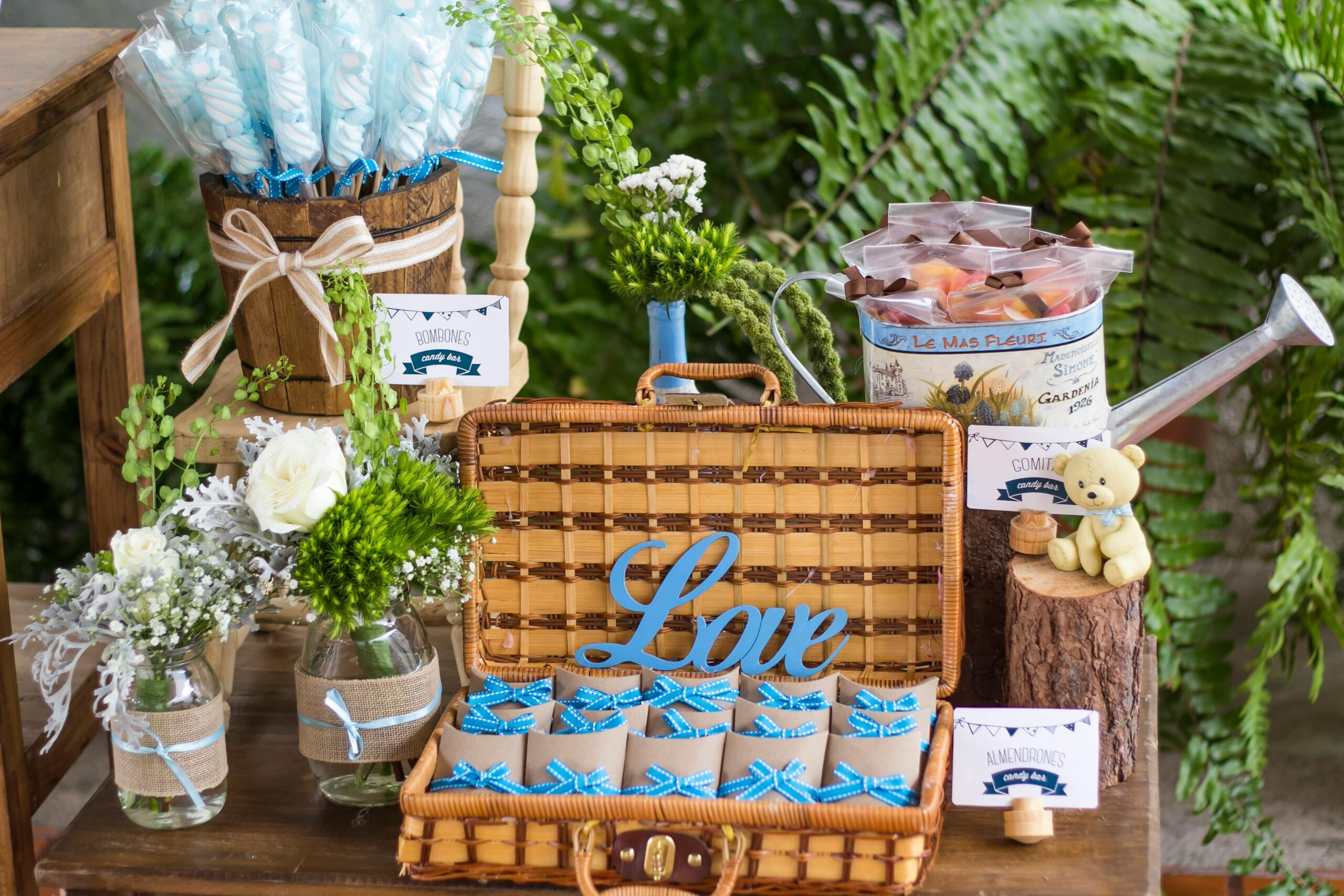 Charming floral and candy display in a wicker basket with decorative elements.